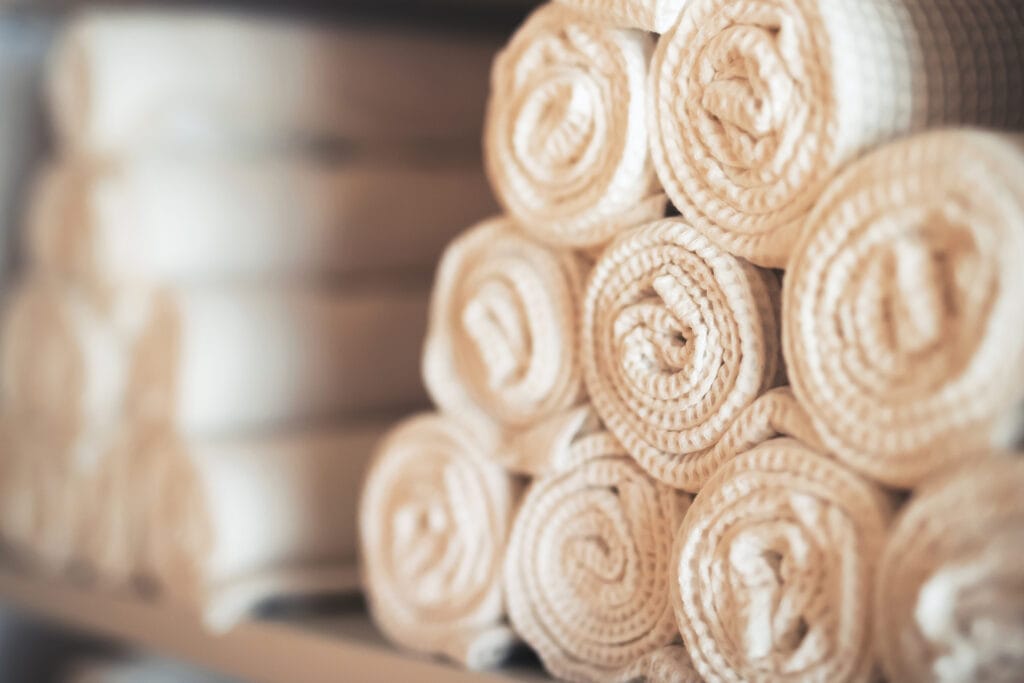 Rolled white towels stacked neatly